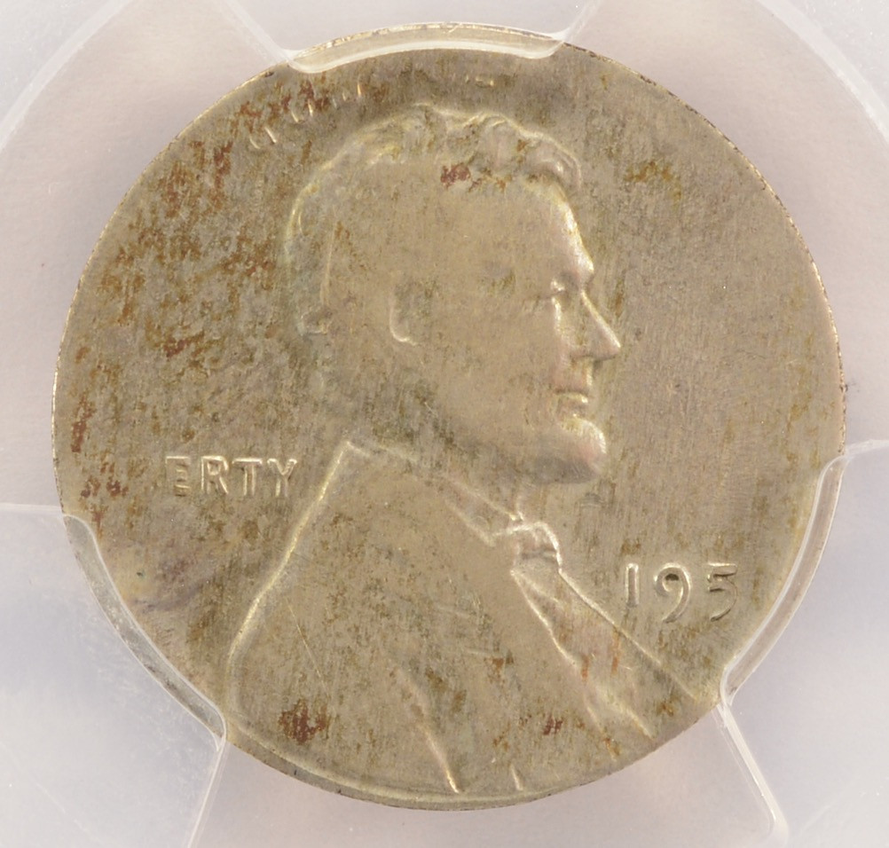 1951-D Lincoln cent struck on a silver dime planchet showing smaller diameter and partial design