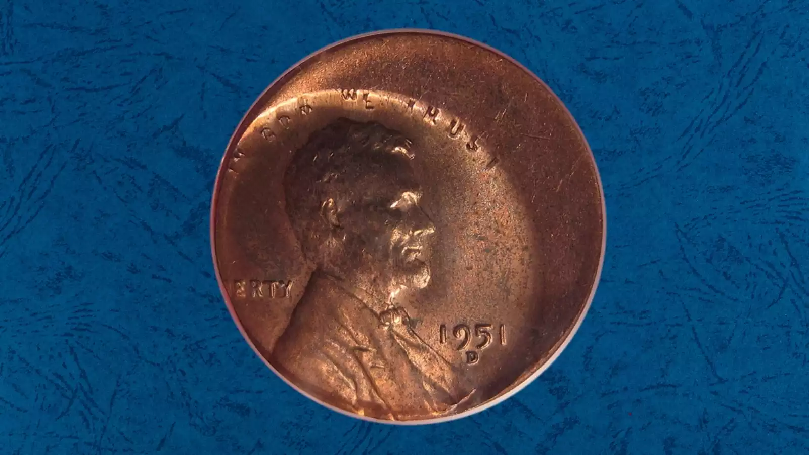 1951 wheat penny with off-center strike showing blank crescent and partial Lincoln design with visible date